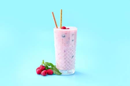 Glass of tasty raspberry smoothie on color backgroundの写真素材