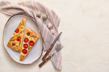 Plate with traditional Italian focaccia on light background