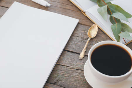 Blank magazine and cup of coffee on wooden backgroundの写真素材