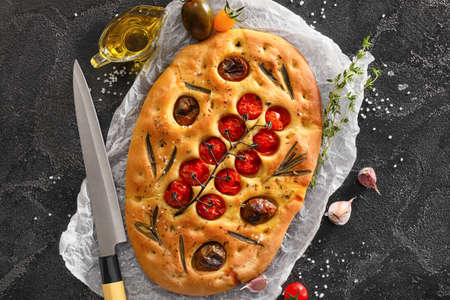 Composition with traditional Italian focaccia on dark backgroundの写真素材
