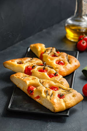 Plate with traditional Italian focaccia on dark backgroundの写真素材