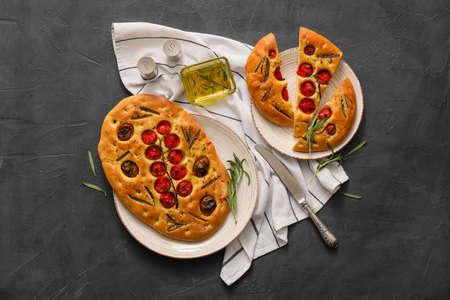 Composition with traditional Italian focaccia on dark background