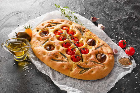 Composition with traditional Italian focaccia on dark backgroundの写真素材