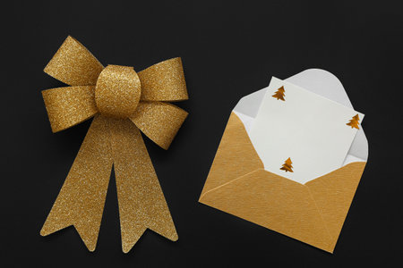 Beautiful envelope and empty paper sheet with decor on dark backgroundの写真素材