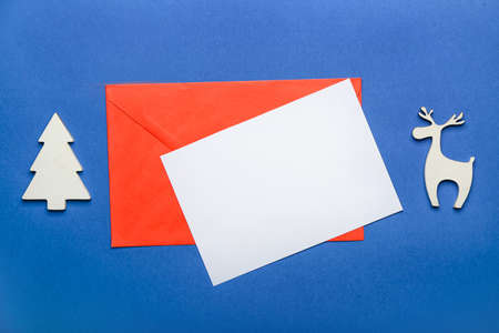 Beautiful Christmas decor, envelope and empty paper sheet on color backgroundの写真素材