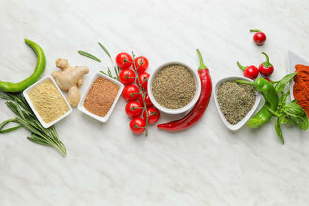 Composition with different spices and herbs on light backgroundの写真素材
