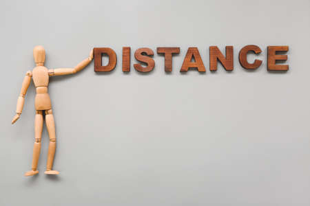 Wooden mannequin with word DISTANCE on gray backgroundの写真素材