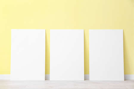 Blank posters near color wallの写真素材