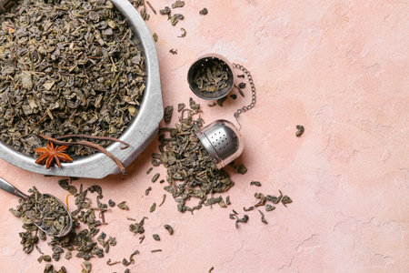 Dish with dry tea leaves on color backgroundの写真素材