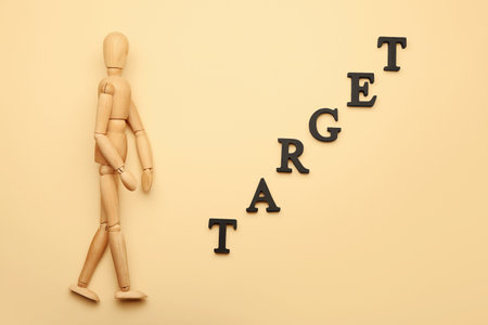 Wooden mannequin with word TARGET on color backgroundの写真素材