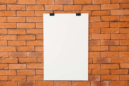 Blank poster hanging on brick wallの写真素材