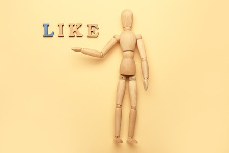 Wooden mannequin with word LIKE on color backgroundの写真素材