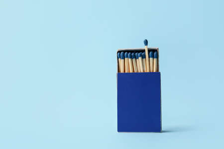 Box with matches on color background. Concept of uniquenessの写真素材
