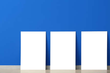 Blank posters near color wall