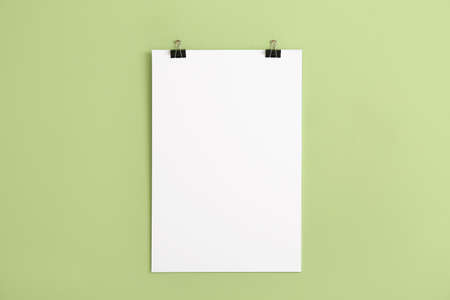 Blank poster hanging on color wallの写真素材