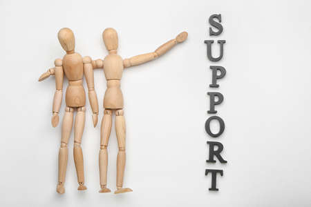 Wooden mannequins with word SUPPORT on white backgroundの写真素材