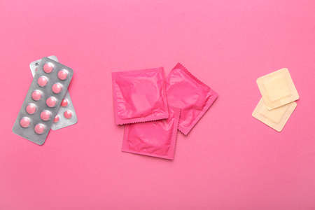 Different contraceptives on color background