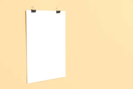 Blank poster hanging on color wall