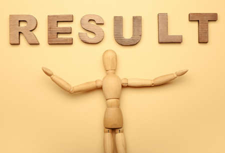 Wooden mannequin with word RESULT on color backgroundの写真素材