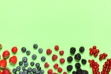 Different tasty berries on color backgroundの写真素材
