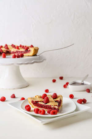 Piece of delicious raspberry pie on light backgroundの写真素材