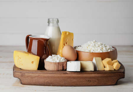 Different dairy products on wooden backgroundの写真素材