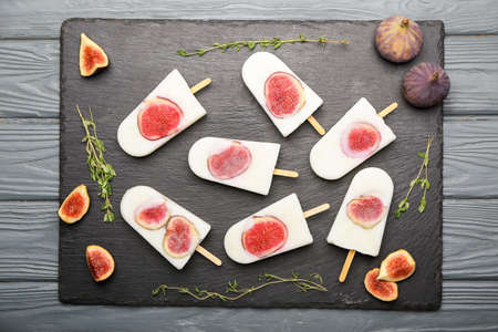 Composition with delicious fig ice-cream on dark wooden background