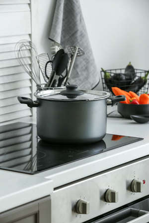 Cooking pot on electric stove in kitchen