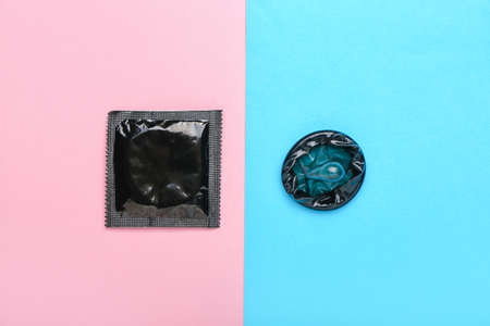 Wrapped and open condoms on color backgroundの写真素材