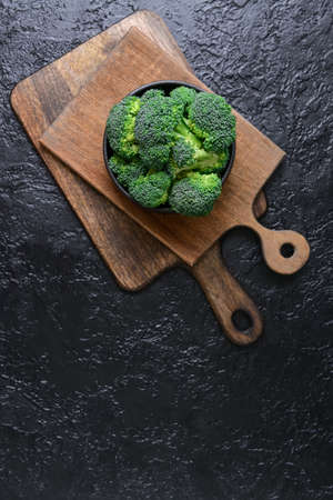 Bowl with fresh broccoli cabbage on dark backgroundの写真素材