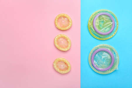 Open condoms on color backgroundの写真素材