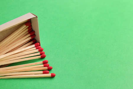 Box with matches on color background