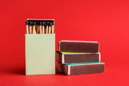 Different boxes with matches on color backgroundの写真素材