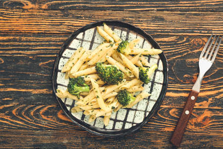Delicious pasta with broccoli on wooden backgroundの写真素材
