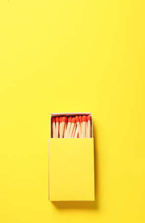 Box with matches on color background