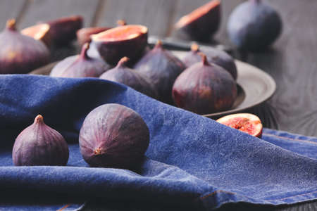 Fresh ripe figs on wooden background