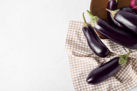 Fresh eggplants on light backgroundの写真素材