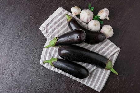 Fresh eggplants on dark backgroundの写真素材
