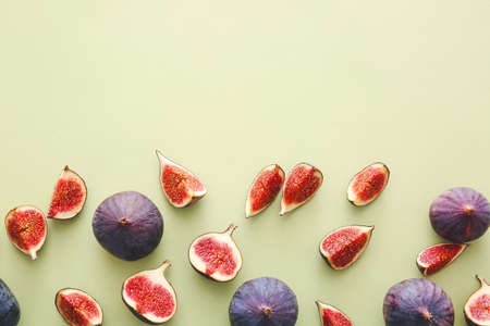 Composition with fresh figs on color background
