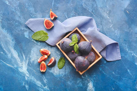 Composition with fresh figs on color background