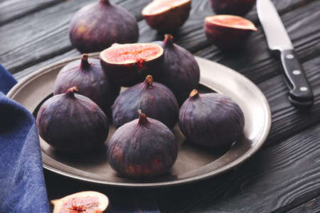 Composition with fresh figs on wooden background