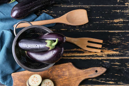 Composition with fresh eggplants on wooden backgroundの写真素材