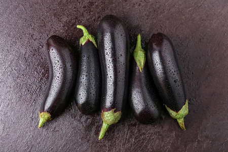 Fresh eggplants on dark backgroundの写真素材