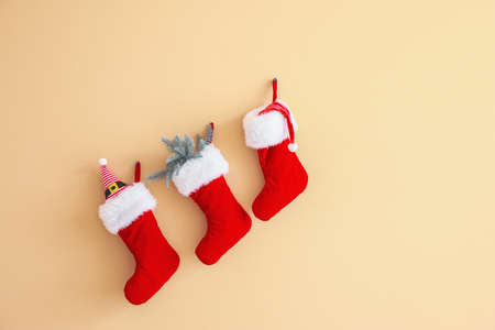 Christmas socks hanging on color wallの写真素材