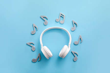 Music notes and headphones on color backgroundの写真素材
