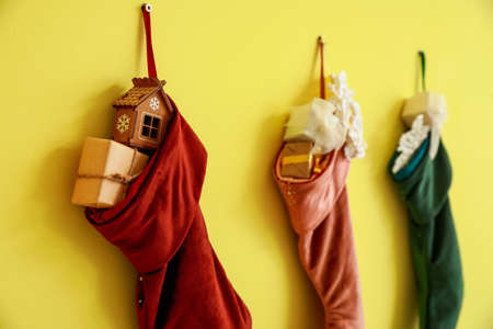 Christmas socks hanging on color wallの写真素材