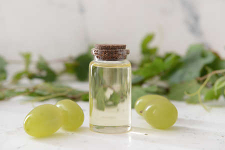 Bottle of grape seed oil on white backgroundの写真素材