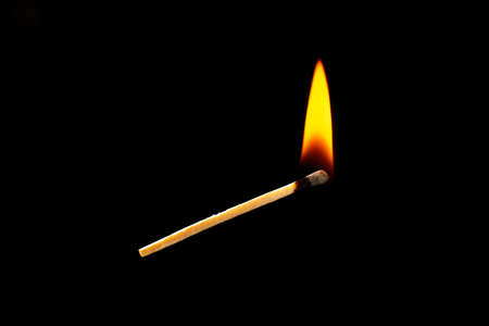 Burning match on dark backgroundの写真素材