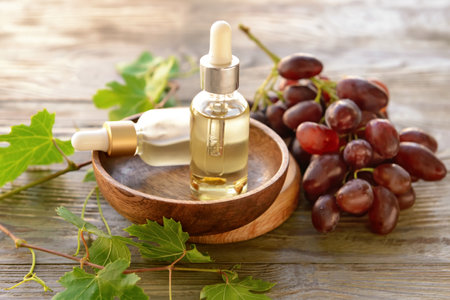 Bottles of grape seed oil on tableの写真素材