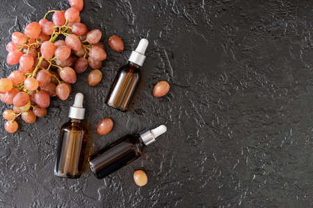 Bottles of grape seed oil on dark backgroundの写真素材